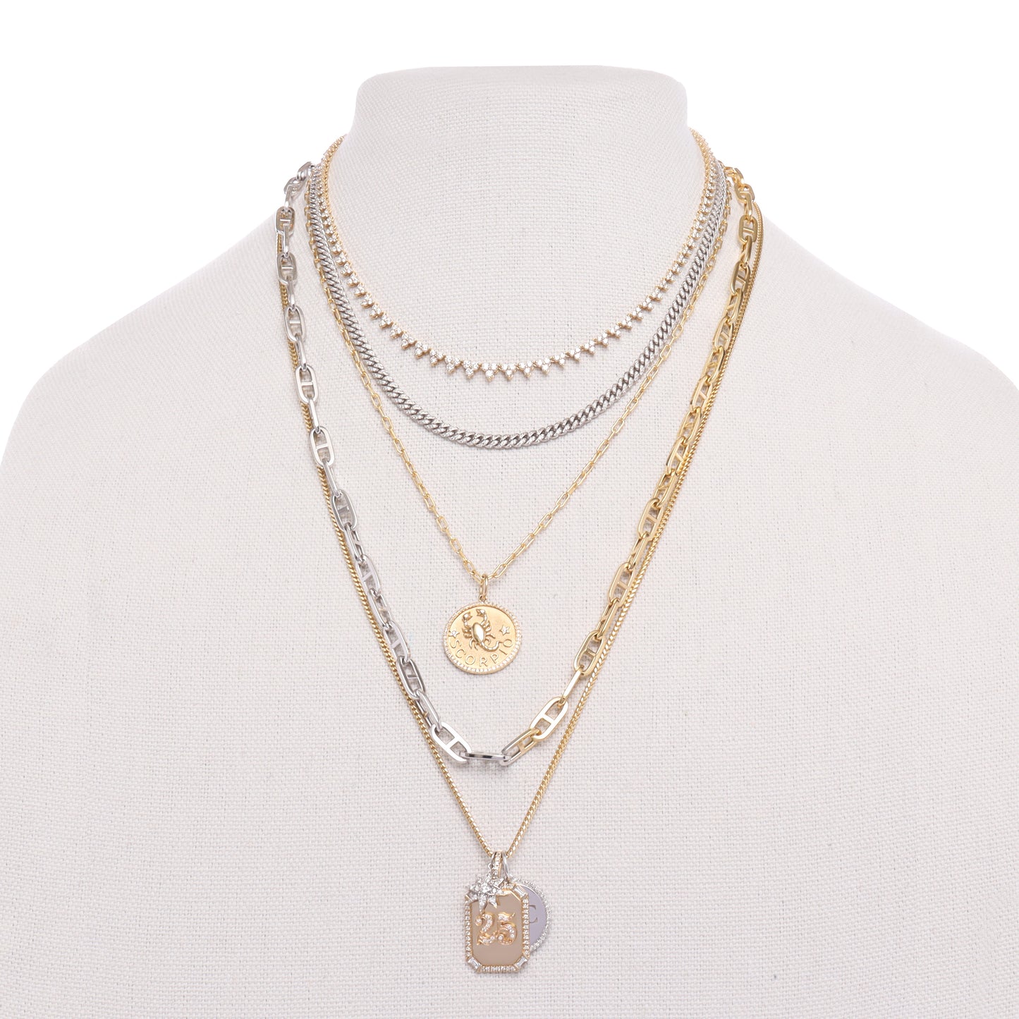 gold chains layered with diamond cuban link necklace and zodiac pendant by the10 jewelry