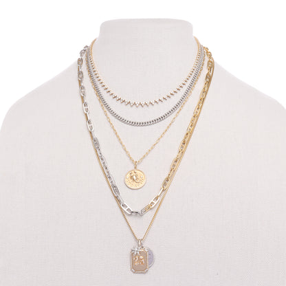 gold chains layered with diamond cuban link necklace and zodiac pendant by the10 jewelry