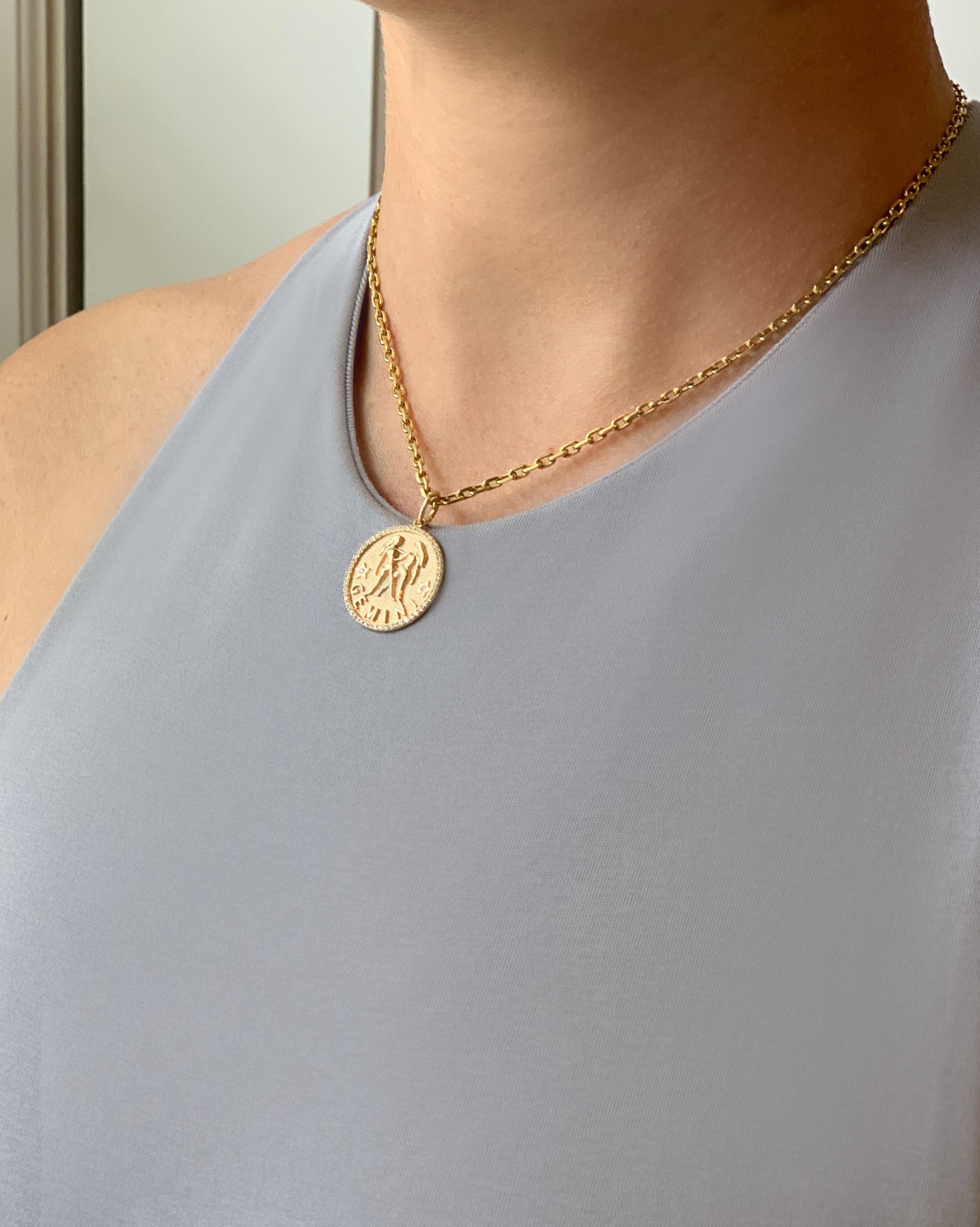 gold chain with zodiac sign pendant